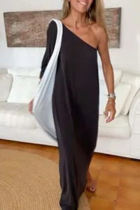 Full-length view of a black one-shoulder loose-fitting knit dress on a female model