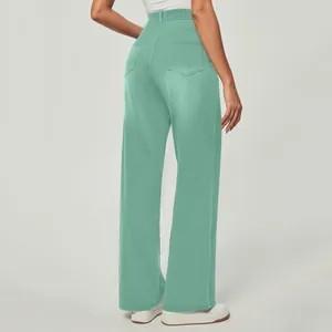 Back view of high waisted mint green straight leg casual pants with pockets