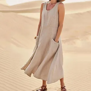 Detail view of a loose sleeveless cotton linen maxi dress with side pockets in desert setting