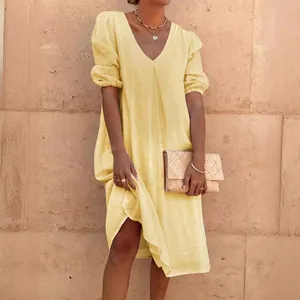 Elegant yellow linen midi dress featuring a V-neck and stylish puff sleeves for casual wear
