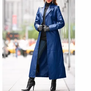 Full-length view of an elegant women's long blue leather trench coat in a city street setting