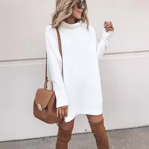 Fashionable white long sleeve knitted sweater dress styled with brown over-knee boots