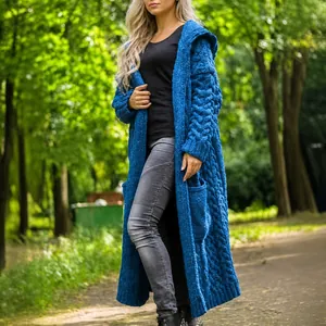Women's royal blue cable knit hooded long cardigan sweater shown in an outdoor setting