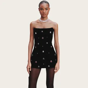 Close-up of black strapless bandage dress with colorful crystal teardrop embellishments