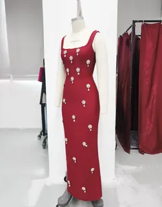 Detail view of a red square-neck bandage dress with elegant rhinestone flower patterns