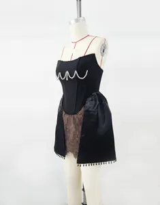 Close-up detail of a black corset dress featuring pearl beads and brown lace panels