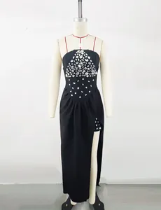 Detailed view of black evening gown with sparkling crystal bodice on mannequin