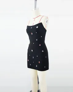 Detailed side view of elegant black bandage dress featuring colorful glass rhinestones