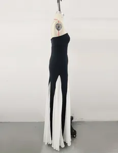 Profile view of a black and white mesh patchwork bandage evening gown on a dress form
