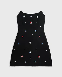Detailed view of a black A-line bandage party dress with colorful teardrop gemstones