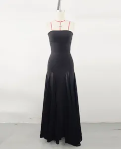 Detailed view of an elegant black evening gown with mesh patchwork on a dress form