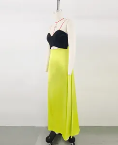 Side profile of a French color-block strapless maxi dress in black and neon green.