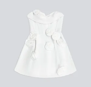 Close-up of white bandage dress featuring elegant 3D flower decorations for parties