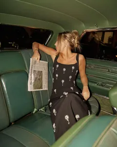 Close-up of elegant black square-neck bandage dress with crystal starburst detailing