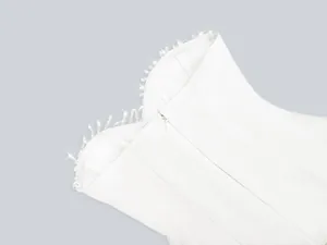 Detail of elegant white evening dress featuring crystal neckline and hidden zipper