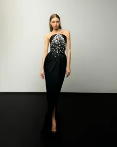 Elegant black strapless evening gown featuring a rhinestone-embellished bodice for parties.