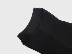Close-up detail of black bandage prom dress showing fabric texture and zipper