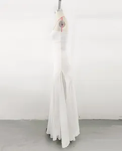 Side view of white strapless bandage evening dress with sheer mesh patchwork inserts