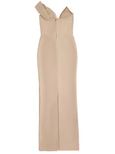 Detail view of the back of an elegant beige one-shoulder bandage dress with a long slit.