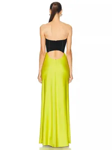 Back view of a lime green and black strapless maxi dress with cutout back detail