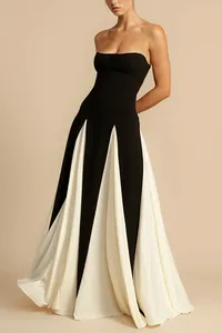 Detail view of a strapless black and white pleated evening gown with mesh panels.