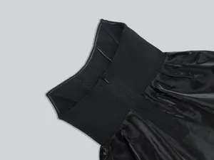Macro view showing the hidden back zipper and bandage texture of this black formal party dress