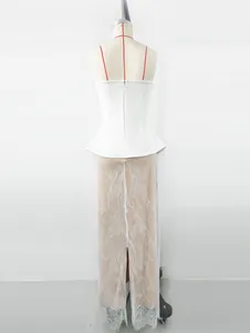 Detailed back view of elegant white peplum top and long lace skirt on studio mannequin
