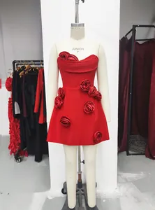 Detailed view of an elegant red strapless mini dress with 3D rose embellishments