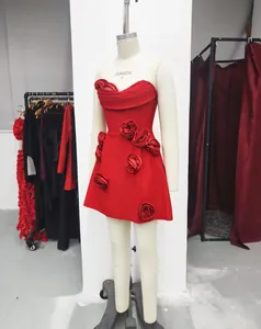 Detailed view of red strapless bandage dress with handcrafted 3D rose floral accents