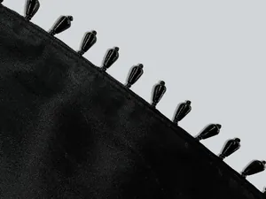 Macro view of elegant black teardrop beaded trim on a luxury formal party dress