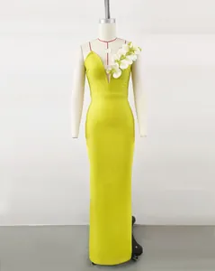 Elegant lime green bandage evening dress with white floral shoulder detail on mannequin