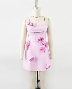 Detailed view of a pink tube bandage mini dress featuring 3D handmade rose floral accents.