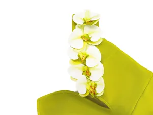 Detailed view of white orchid flower appliques on a lime green one-shoulder bandage dress.