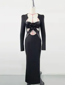Detailed macro view of black evening bandage dress with feather and flower decor