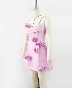 Detailed side view of elegant pink strapless bandage dress with 3D floral embellishments
