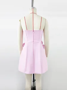 Back detail of a pink strapless bandage mini dress featuring a concealed zipper closure.