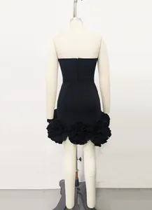 Detailed back view of an elegant black strapless bandage dress with ruffled floral hem.