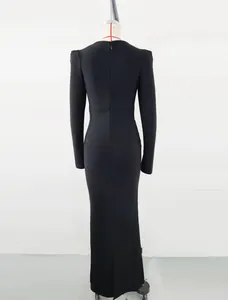 Detailed back view of an elegant black long-sleeved bandage maxi dress on a mannequin.