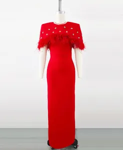Vista detallada del vestido de noche rojo con capa de plumas de avestruz y diamantes