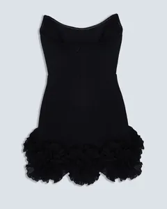 Detailed back view of an elegant black bandage mini dress featuring large 3D ruffled flower hem