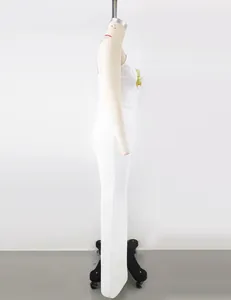 Side view detail of an elegant white one-shoulder bandage dress with a floral accent