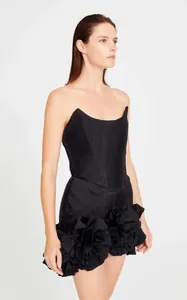 Close-up of an elegant black strapless mini dress with 3D flower detail for party wear.