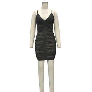Close-up of black ruched mesh bandage dress with deep V-neck and slim fit