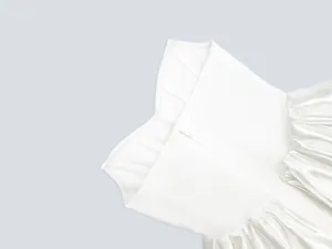 Dettaglio ravvicinato del corsetto bianco con stecche e vita a pieghe per festa