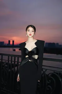 Elegant black bandage evening dress featuring unique cut-outs and a feather detail ornament