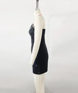 Side profile of a black bandage mini dress with silver rhinestone embellishments