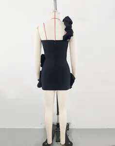 Detailed back view of a black one-shoulder party dress with elegant ruffle decorations