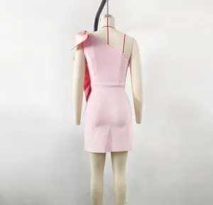 Detailed back view of a Barbie pink satin one-shoulder dress with an oversized bow