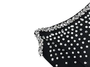 Macro view of sparkling crystal rhinestone embellishments on a black bandage party dress