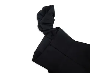 Detail view of black ruffle sleeve and invisible zipper on elegant party dress